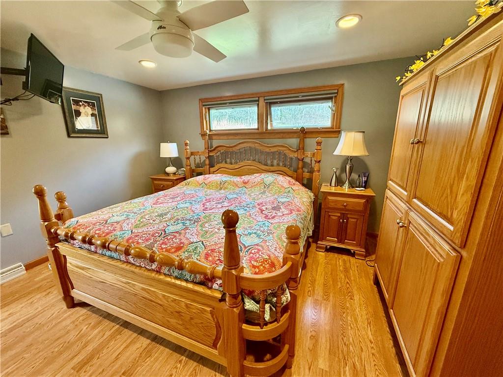 198 Leslie Road Valencia, PA 16059 - Photo 20 of 43 a bedroom with a bed and wooden floor