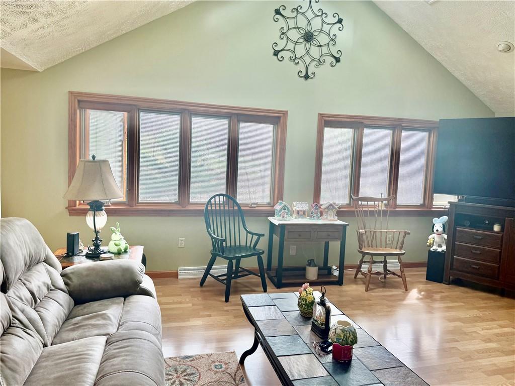 198 Leslie Road Valencia, PA 16059 - Photo 24 of 43 a living room with furniture a fireplace and a table