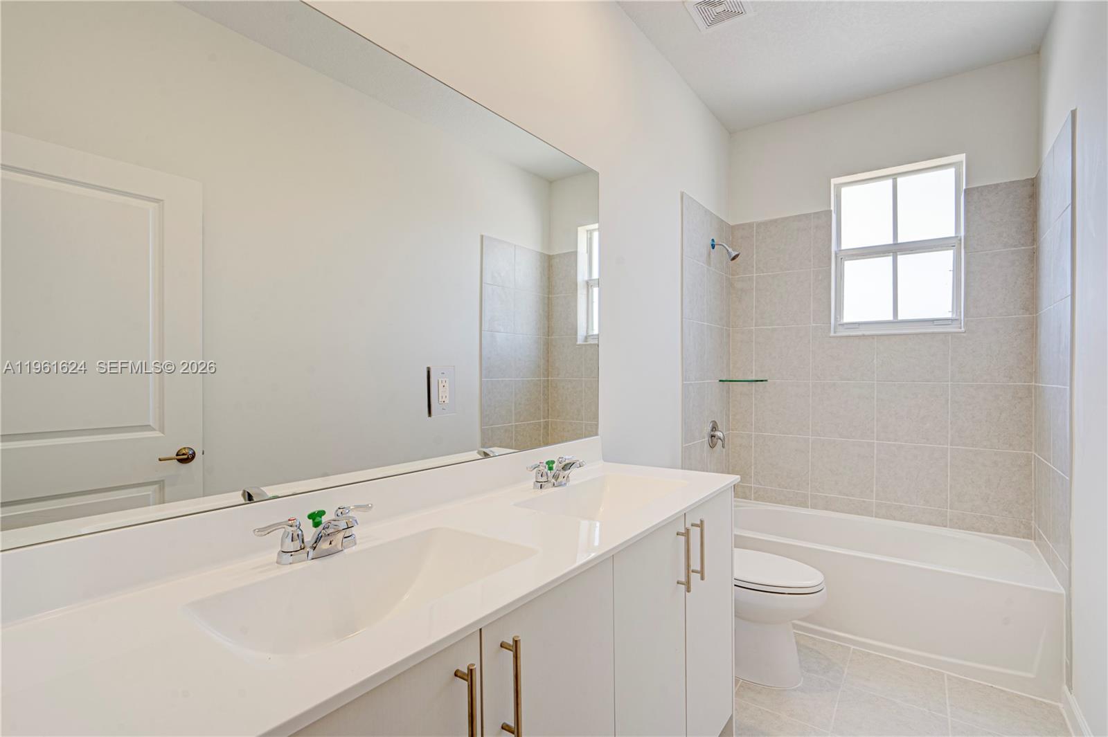 2728 Southeast 24th Court Homestead, FL 33035 - Photo 11 of 18 a bathroom with a sink a toilet and shower