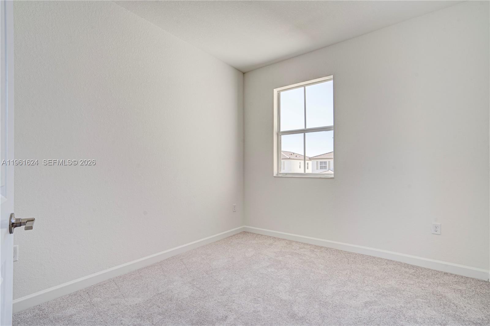 2728 Southeast 24th Court Homestead, FL 33035 - Photo 14 of 18 an empty room with a window