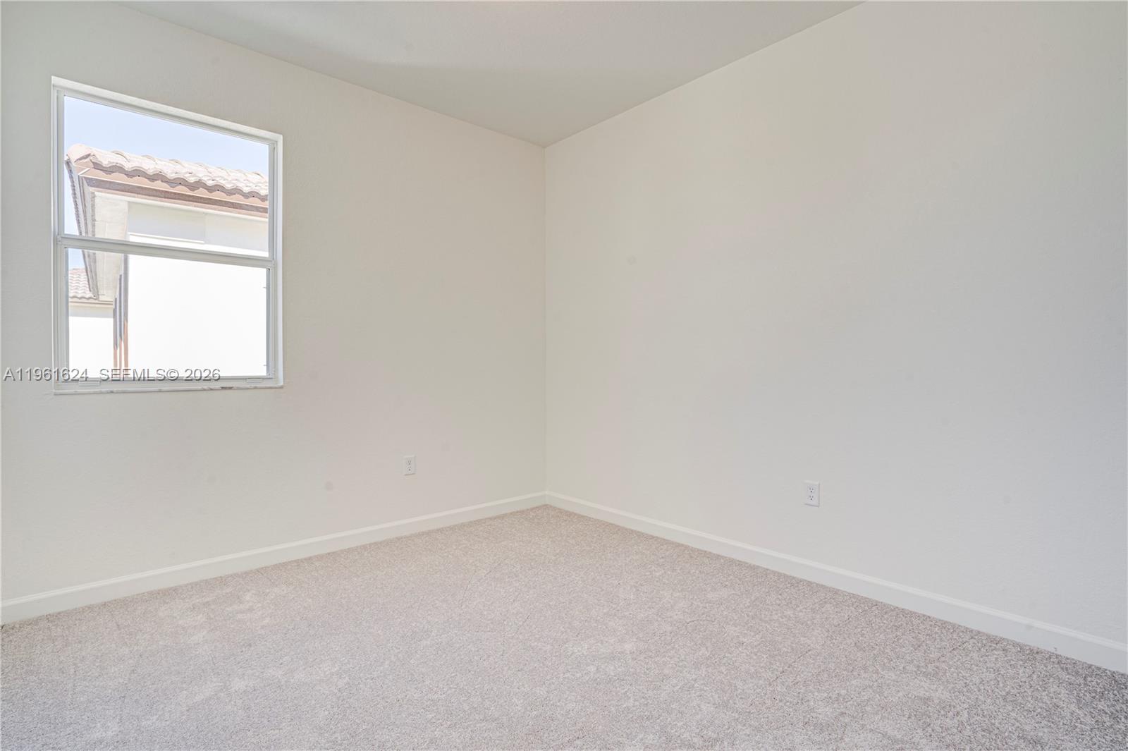 2728 Southeast 24th Court Homestead, FL 33035 - Photo 15 of 18 an empty room with a window