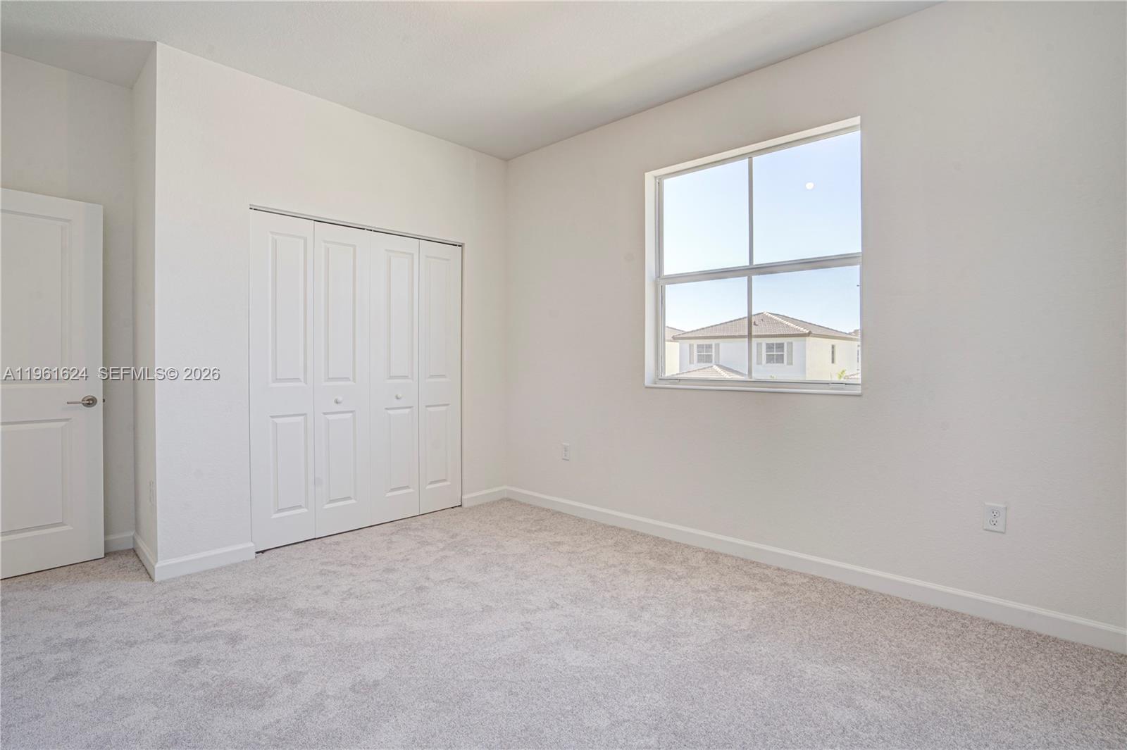 2728 Southeast 24th Court Homestead, FL 33035 - Photo 17 of 18 an empty room with windows