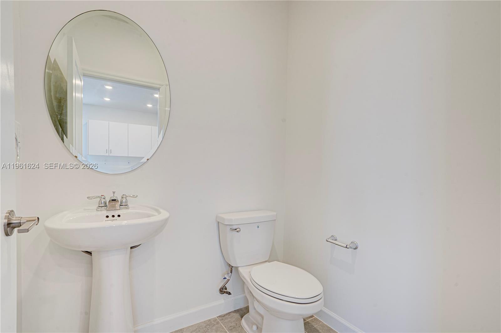 2728 Southeast 24th Court Homestead, FL 33035 - Photo 18 of 18 a bathroom with a sink mirror and toilet
