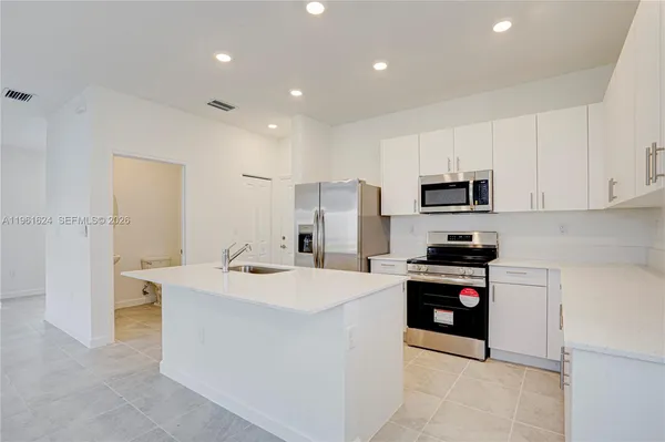 a kitchen that has a sink and a stove in it