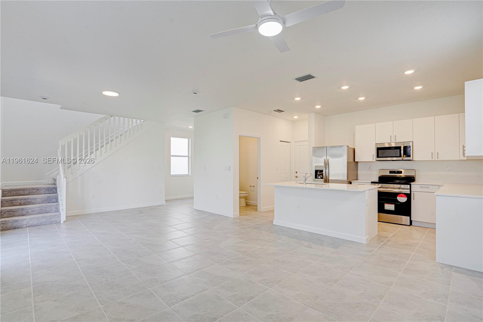 2728 Southeast 24th Court Homestead, FL 33035 - Photo 4 of 18 a view of kitchen with stainless steel appliances refrigerator stove microwave and cabinets