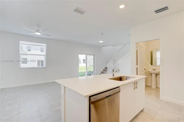 a kitchen with stainless steel appliances kitchen island a sink stove and cabinets