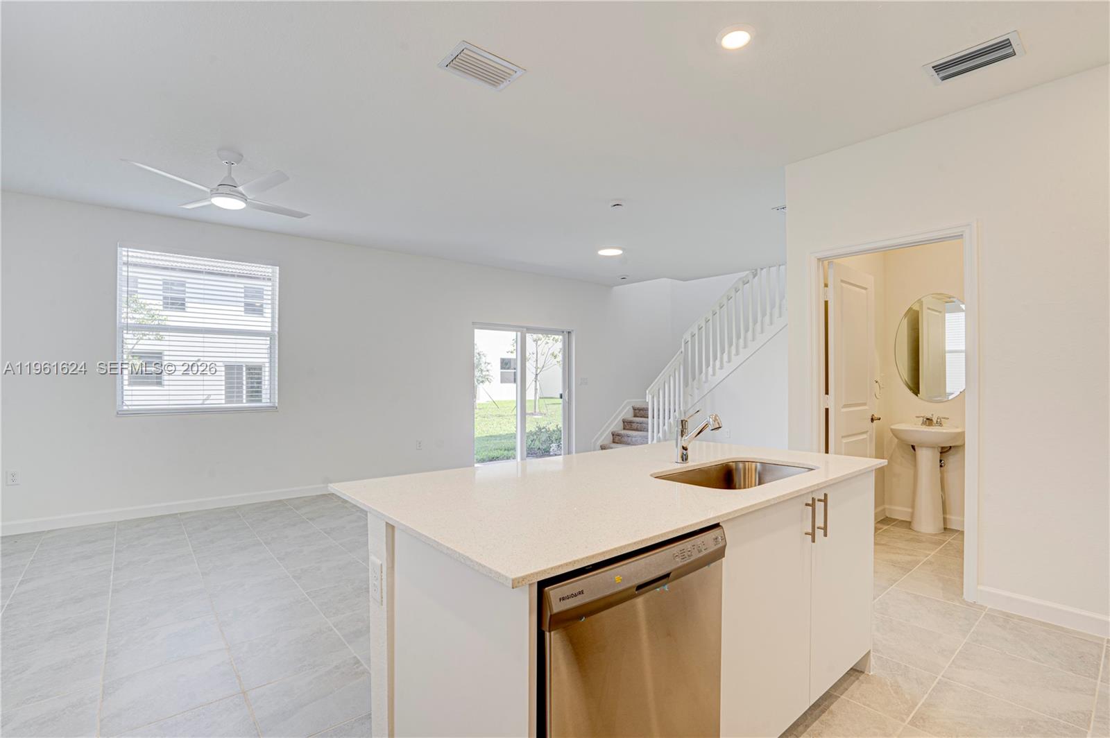 2728 Southeast 24th Court Homestead, FL 33035 - Photo 6 of 18 a kitchen with stainless steel appliances kitchen island a sink stove and cabinets