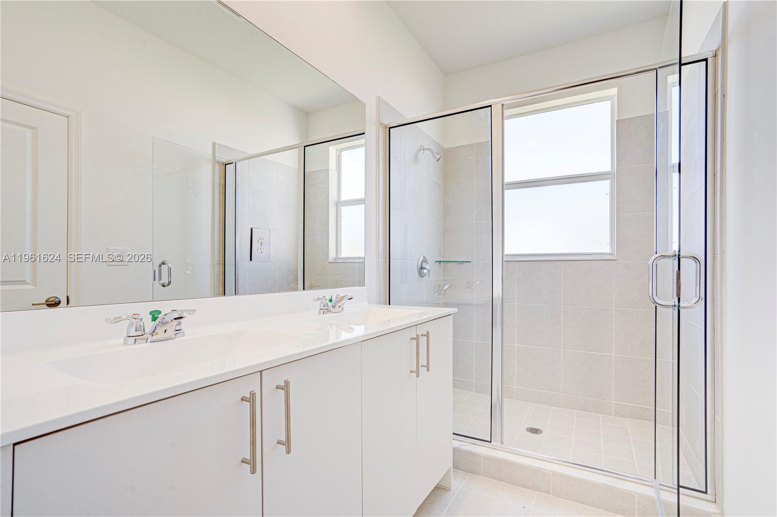 2728 Southeast 24th Court Homestead, FL 33035 - Photo 9 of 18 a view of bathroom with a sink mirror and shower