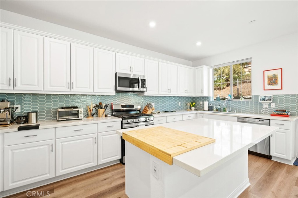 1852 Red Willow Way Oceanside, CA 92056 - Photo 11 of 52 a kitchen with cabinets appliances a sink and a counter top space