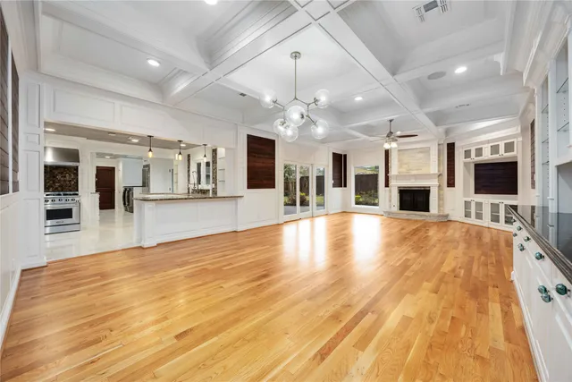 a large room with pool table and windows