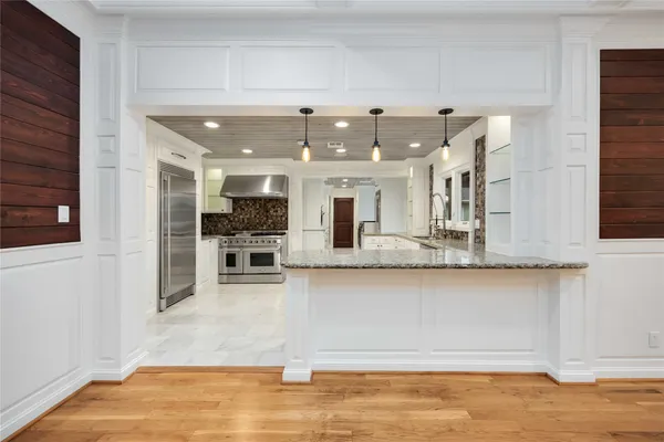 a kitchen with stainless steel appliances granite countertop a stove sink and cabinets