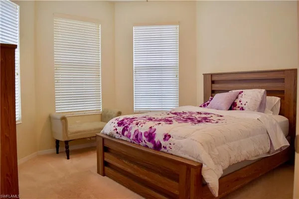 a bedroom with a bed and a chair