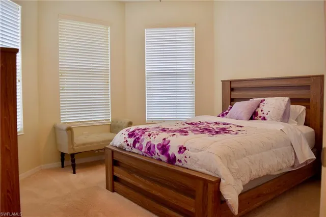 a bedroom with a bed and a chair