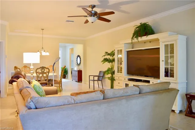 a living room with furniture tv and a flat screen tv