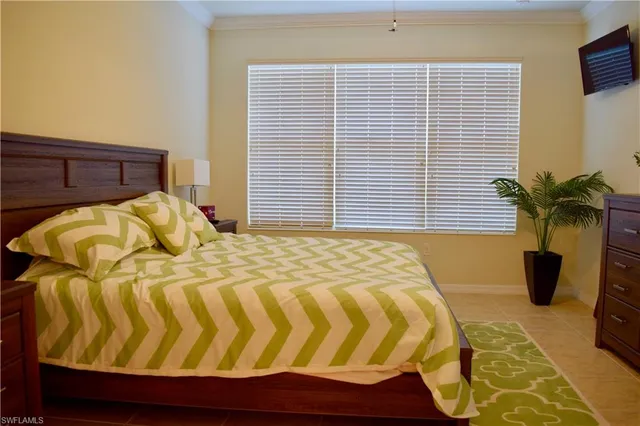 a bedroom with a bed and a potted plant