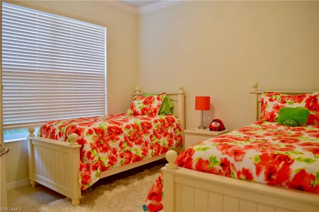 a bedroom with two beds and a lamp