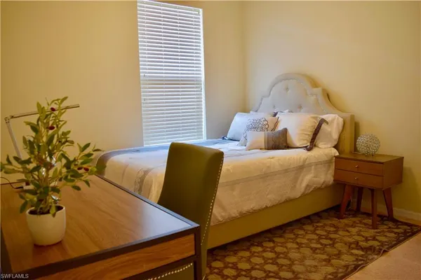 a bed sitting in a bedroom next to a window