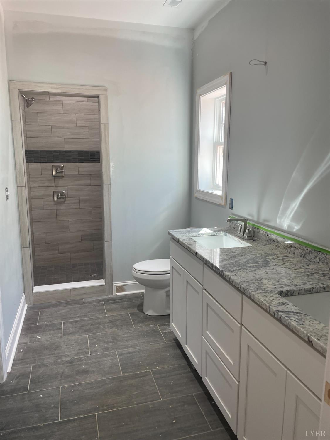1075 Everett Road Forest, VA 24551 - Photo 8 of 12 a bathroom with a granite countertop sink a toilet and shower