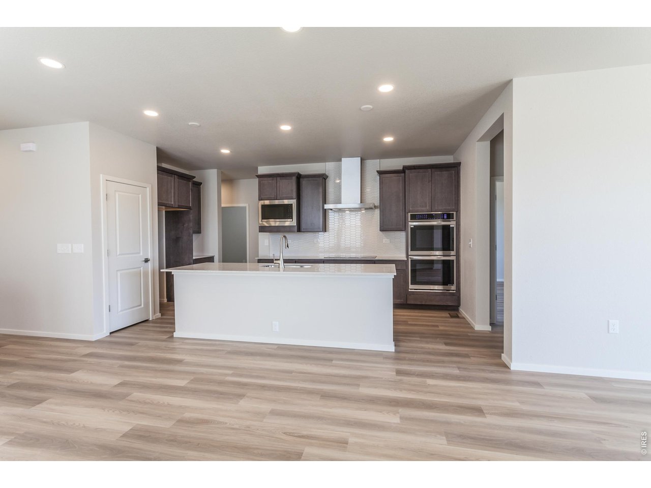 792 Chatter Road Windsor, CO 80550 - Photo 16 of 49 a view of kitchen with kitchen island microwave oven and refrigerator
