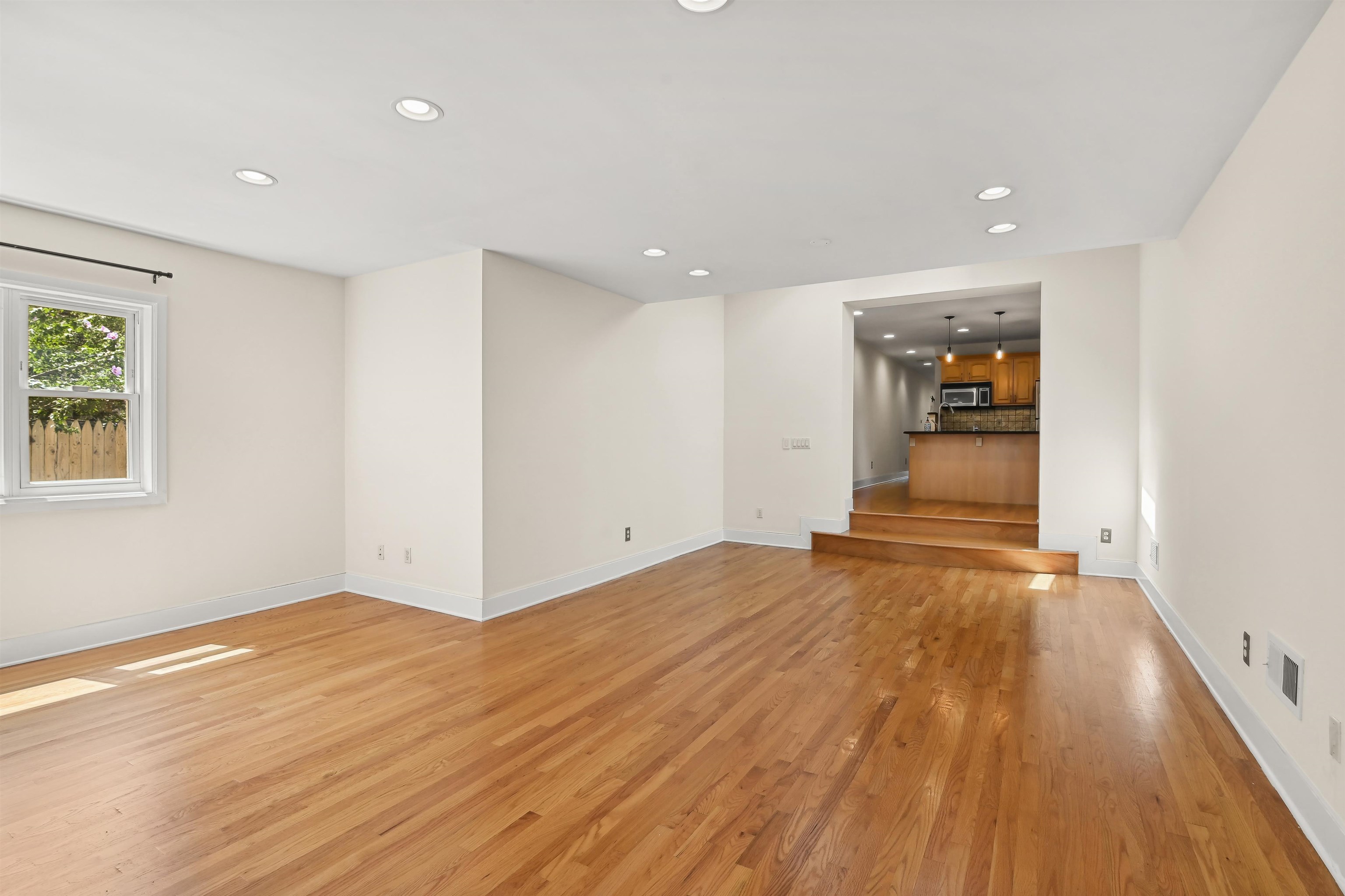 8 Carroll Place Weehawken, NJ 07086 - Photo 18 of 21 a view of an empty room with wooden floor and a window