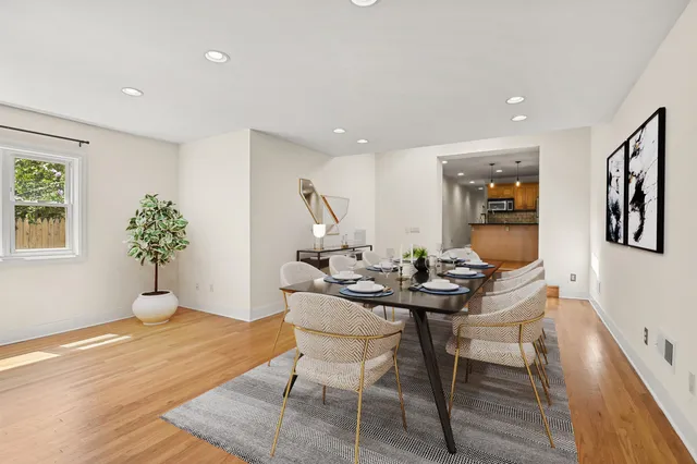 a view of a dining room with furniture and wooden floor