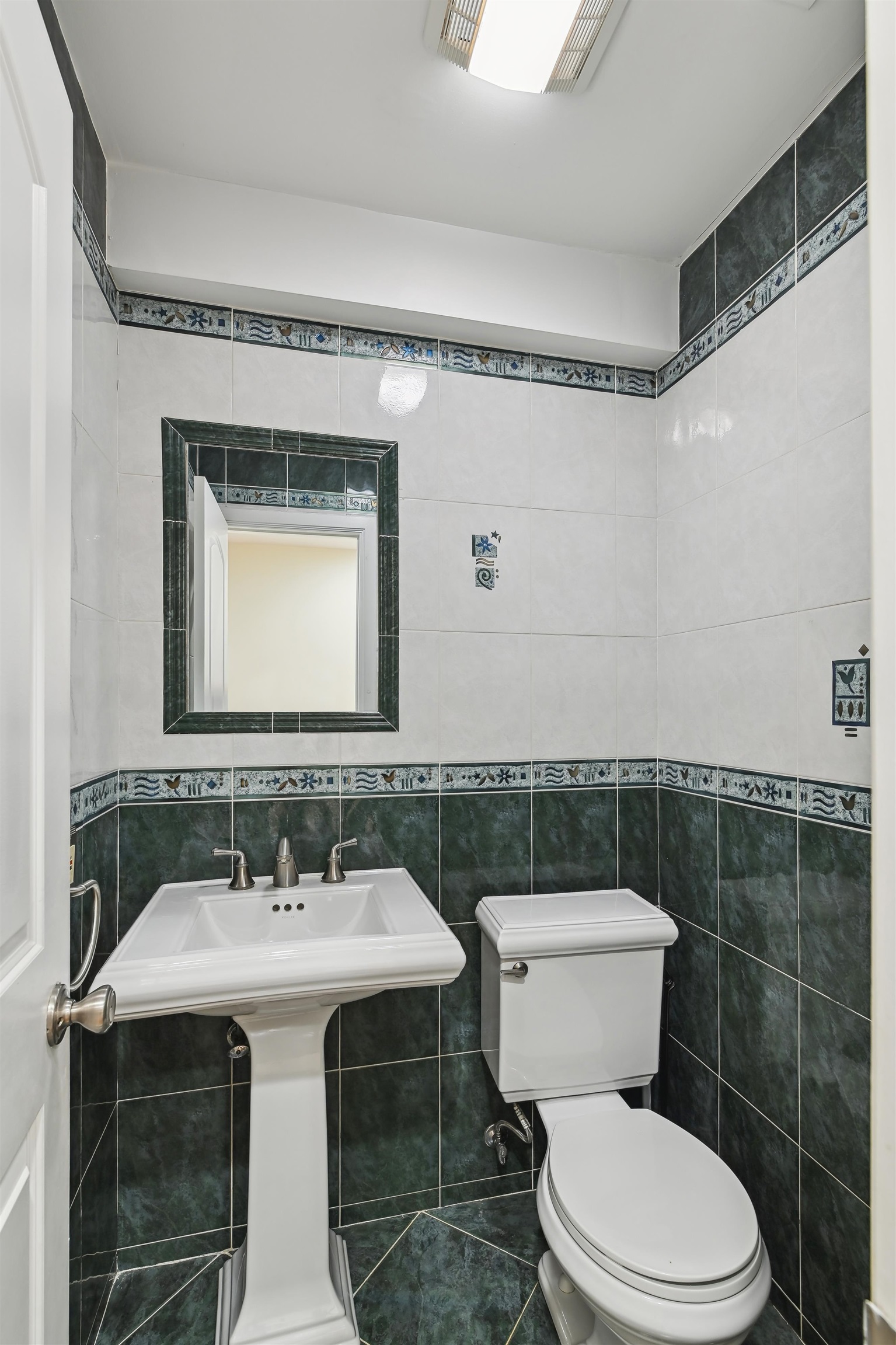 8 Carroll Place Weehawken, NJ 07086 - Photo 4 of 21 a bathroom with a toilet a sink and mirror