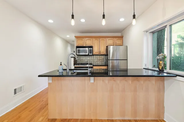 a large kitchen with stainless steel appliances kitchen island a large island in the center