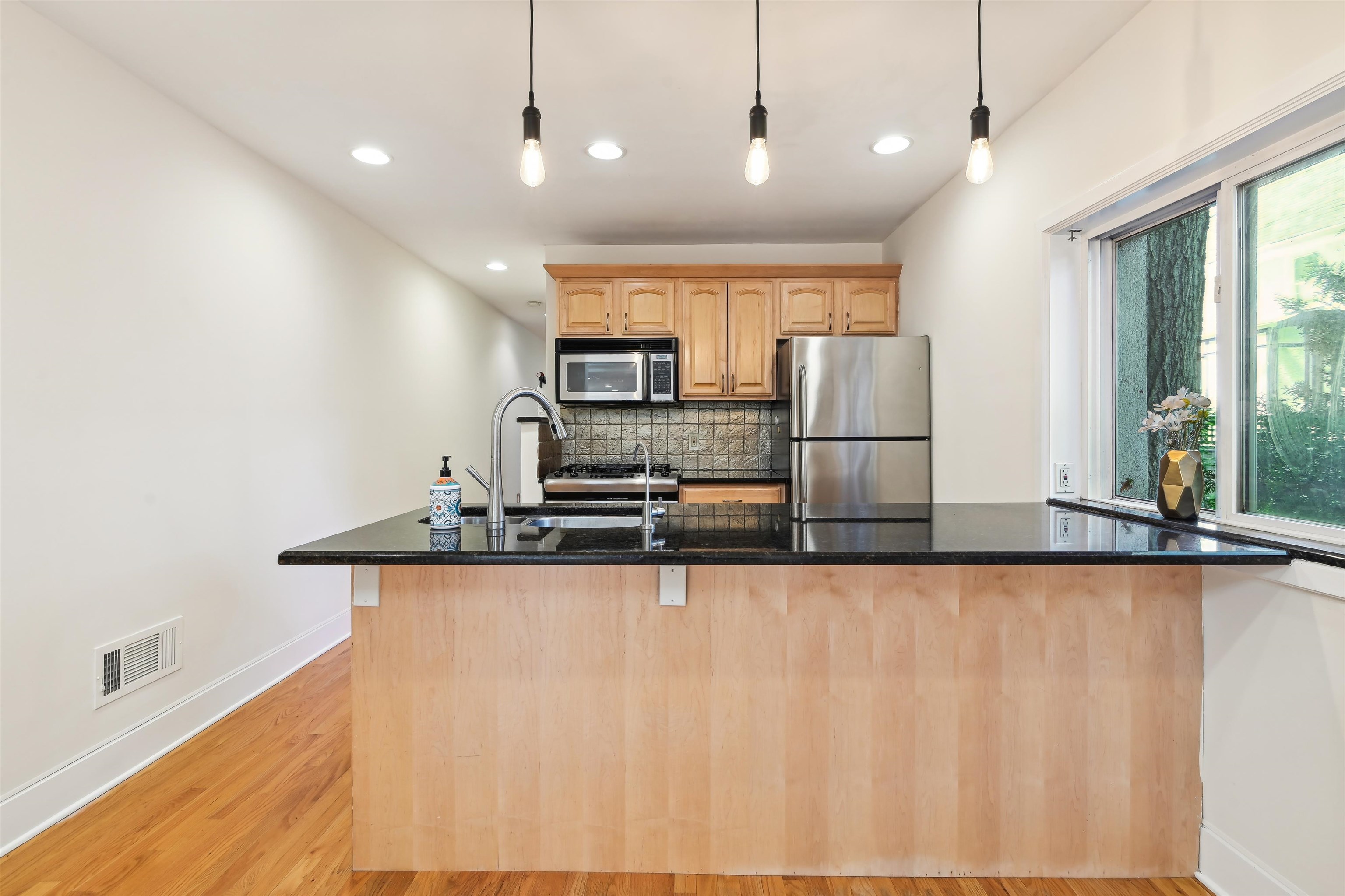 8 Carroll Place Weehawken, NJ 07086 - Photo 5 of 21 a large kitchen with stainless steel appliances kitchen island a large island in the center