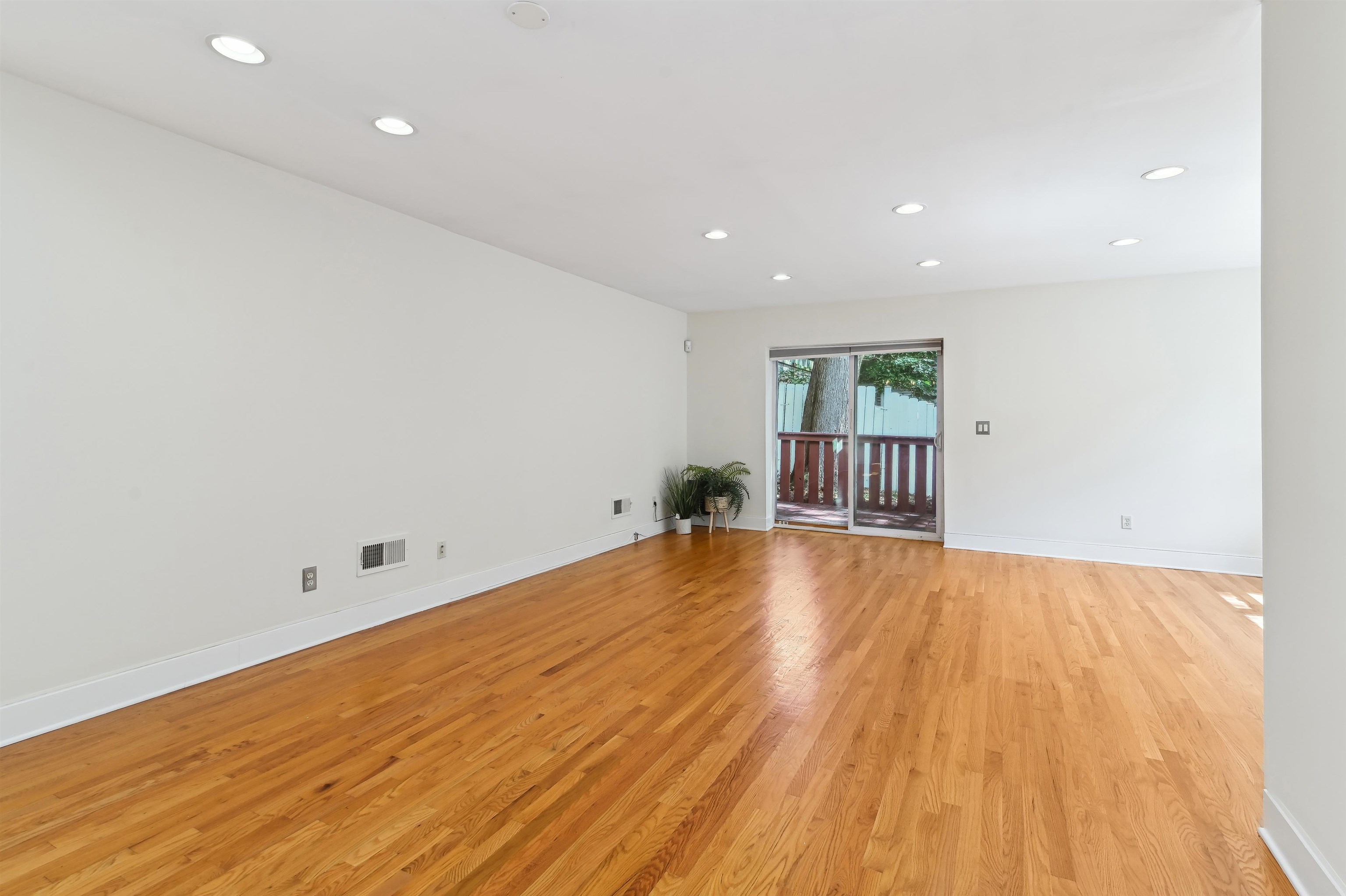 8 Carroll Place Weehawken, NJ 07086 - Photo 6 of 21 an empty room with wooden floor and natural light
