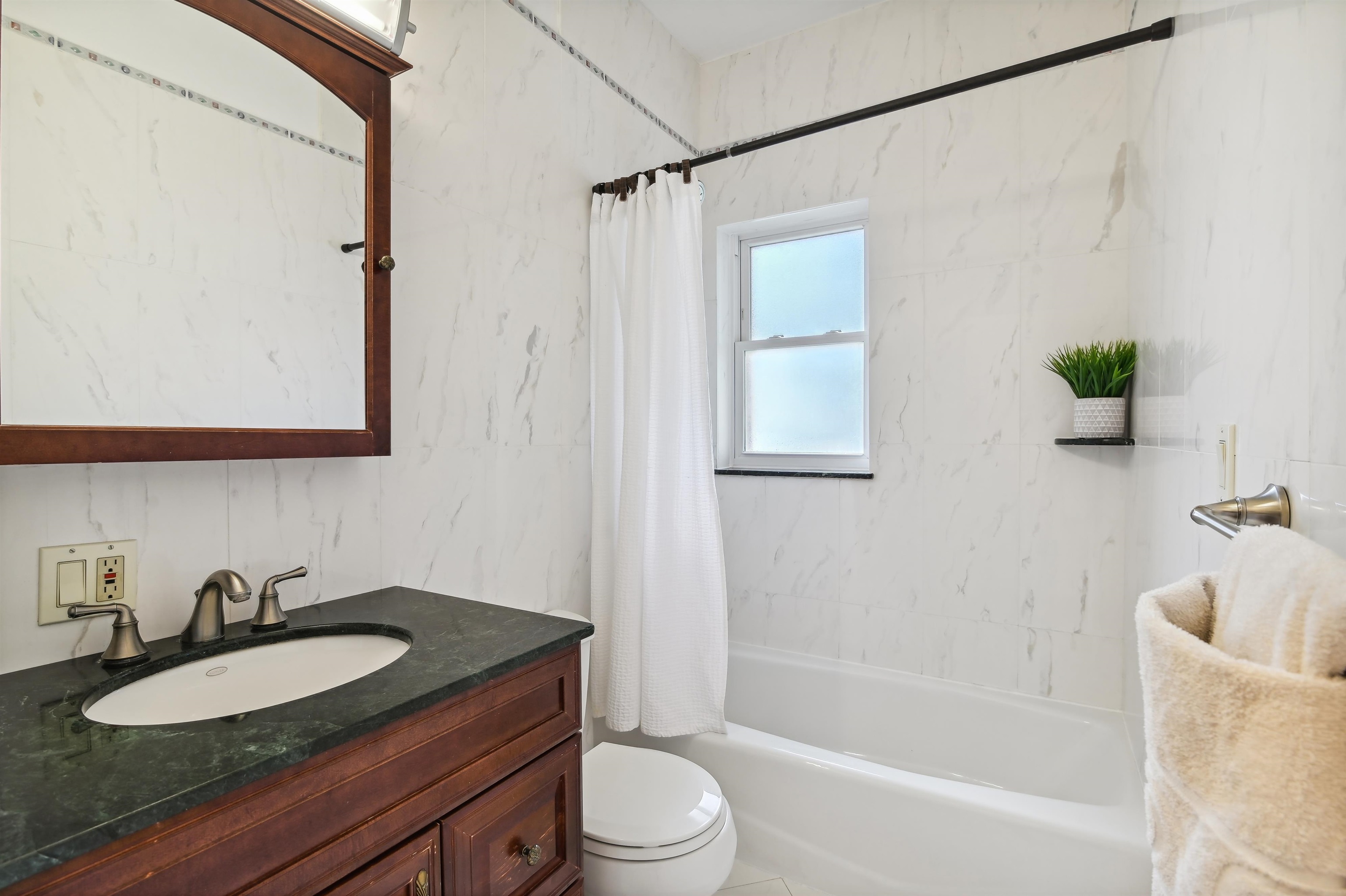8 Carroll Place Weehawken, NJ 07086 - Photo 10 of 21 a bathroom with a granite countertop sink mirror vanity and toilet