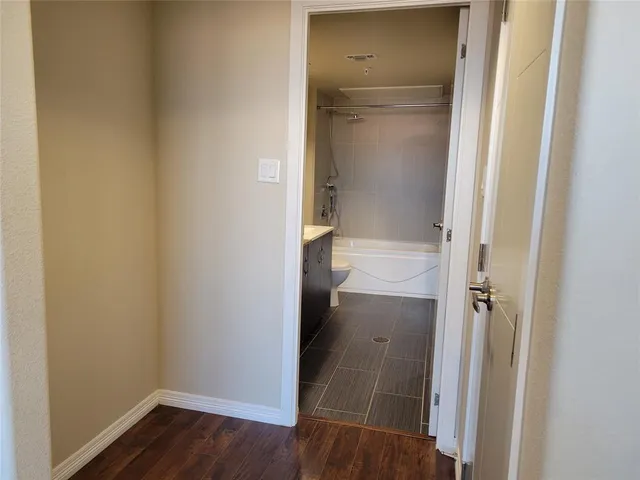 a view of room with wooden floor