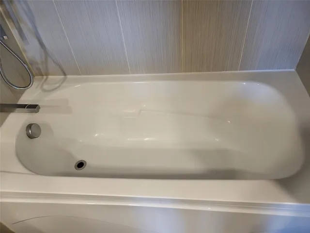 a view of water heater room with wooden floor