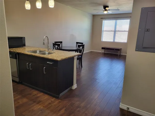 a view of a kitchen counter space and wooden floor