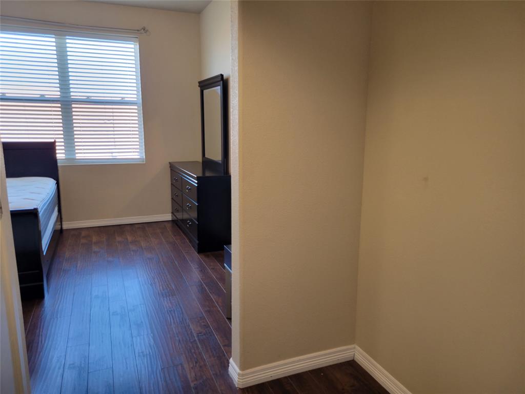 1100 Trinity Mills, Unit 2005 Carrollton, TX 75006 - Photo 7 of 18 a view of a room with wooden floor and a window