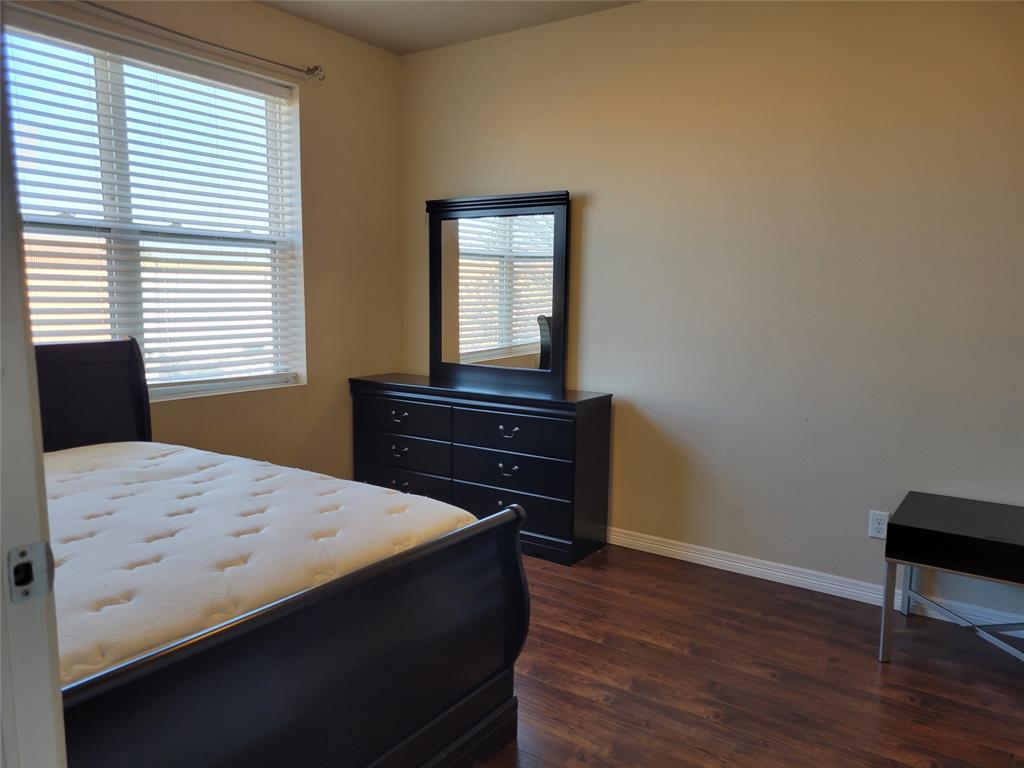 1100 Trinity Mills, Unit 2005 Carrollton, TX 75006 - Photo 8 of 18 a bedroom with a bed and a window