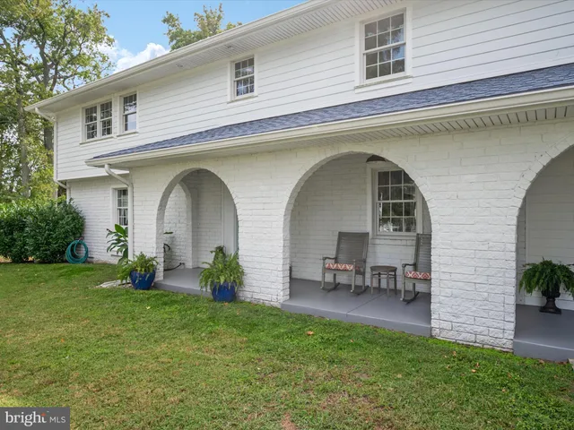 a dining room with furniture a potted plant and a chandelier