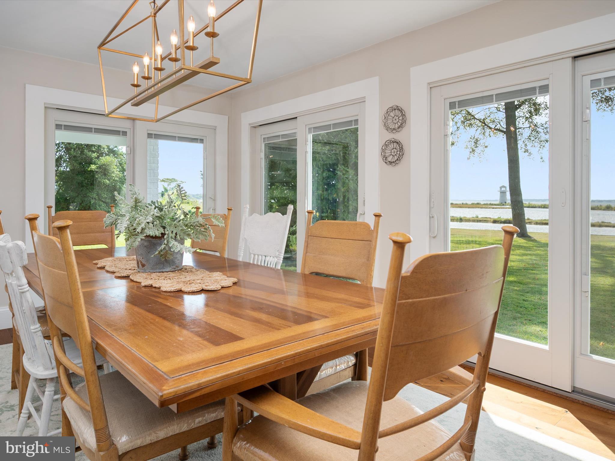 133 Kilby Point Queenstown, MD 21658 - Photo 32 of 87 a dining room with furniture a potted plant and a chandelier
