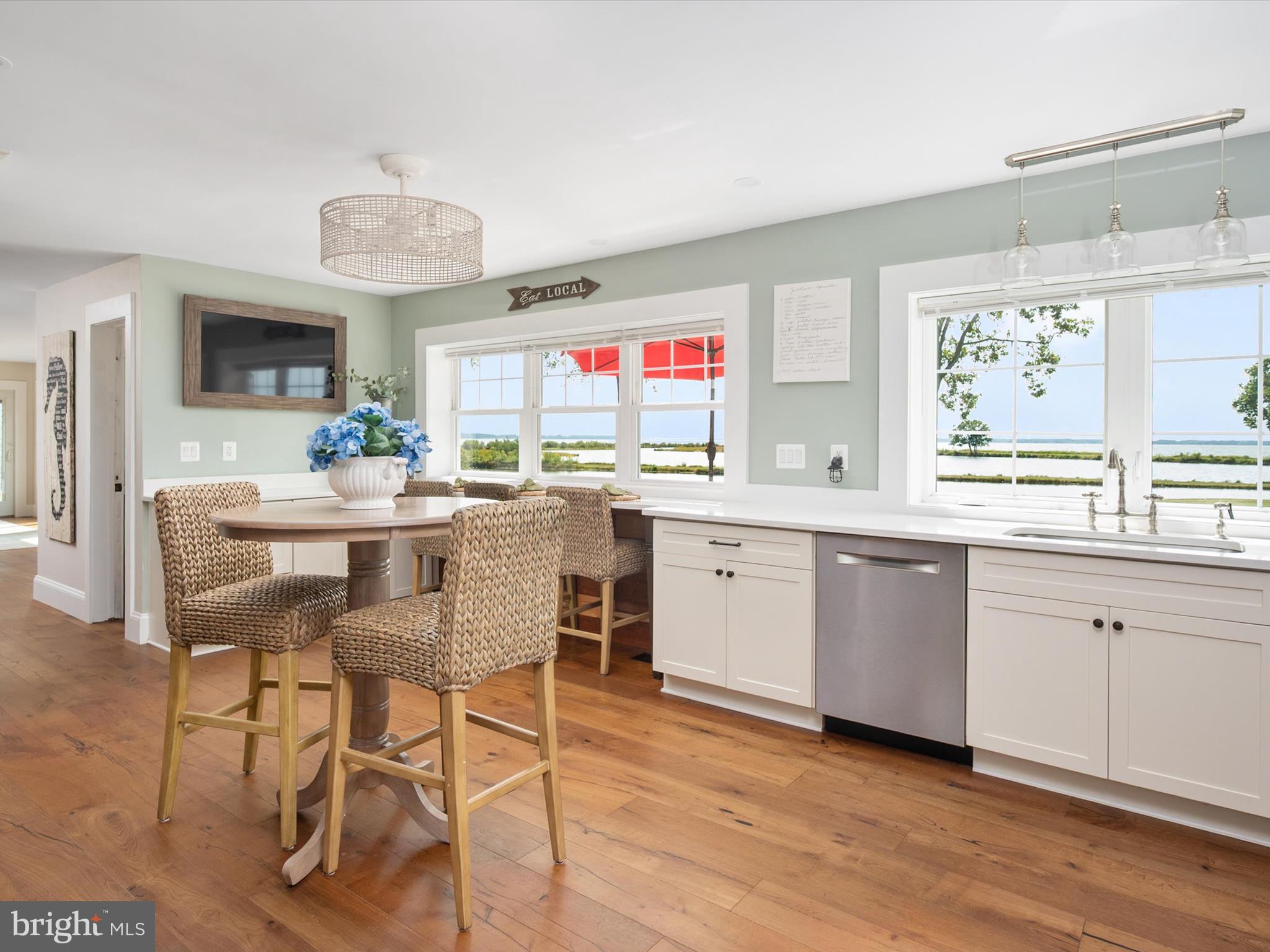 133 Kilby Point Queenstown, MD 21658 - Photo 35 of 87 a kitchen with a dining table chairs cabinets and stainless steel appliances