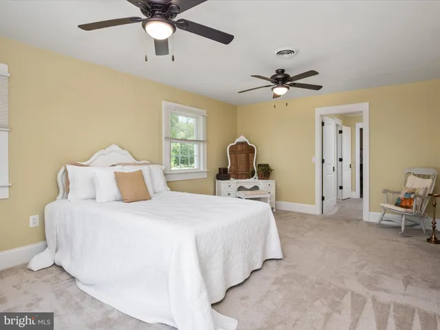 a view of a house with a big yard and potted plants