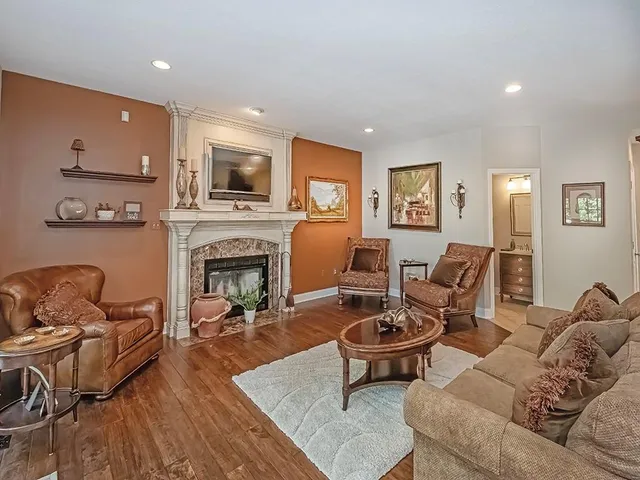 a living room with furniture fireplace and a flat screen tv
