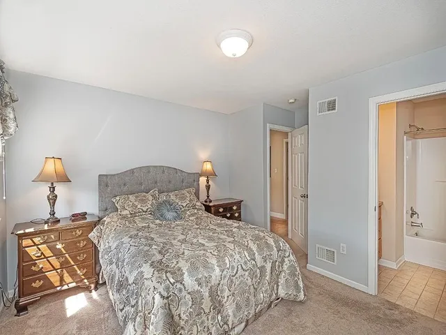 a bedroom with a bed and a lamp