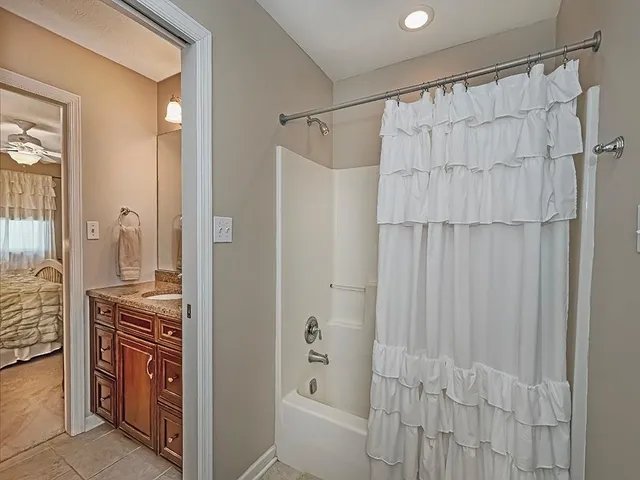 a bathroom with a shower curtain and a sink