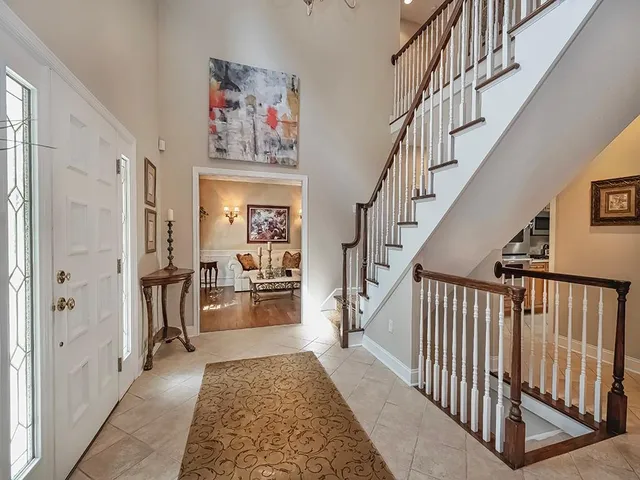 a view of entryway and hall with wooden floor