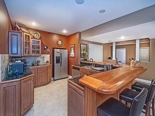 a kitchen with stainless steel appliances granite countertop a sink and cabinets