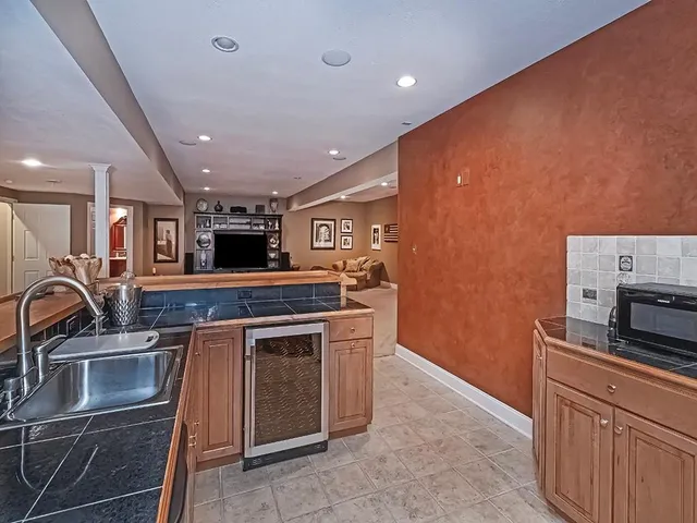 a kitchen with stainless steel appliances granite countertop a sink and a microwave