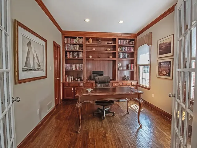 a view of a workspace with furniture and wooden floor