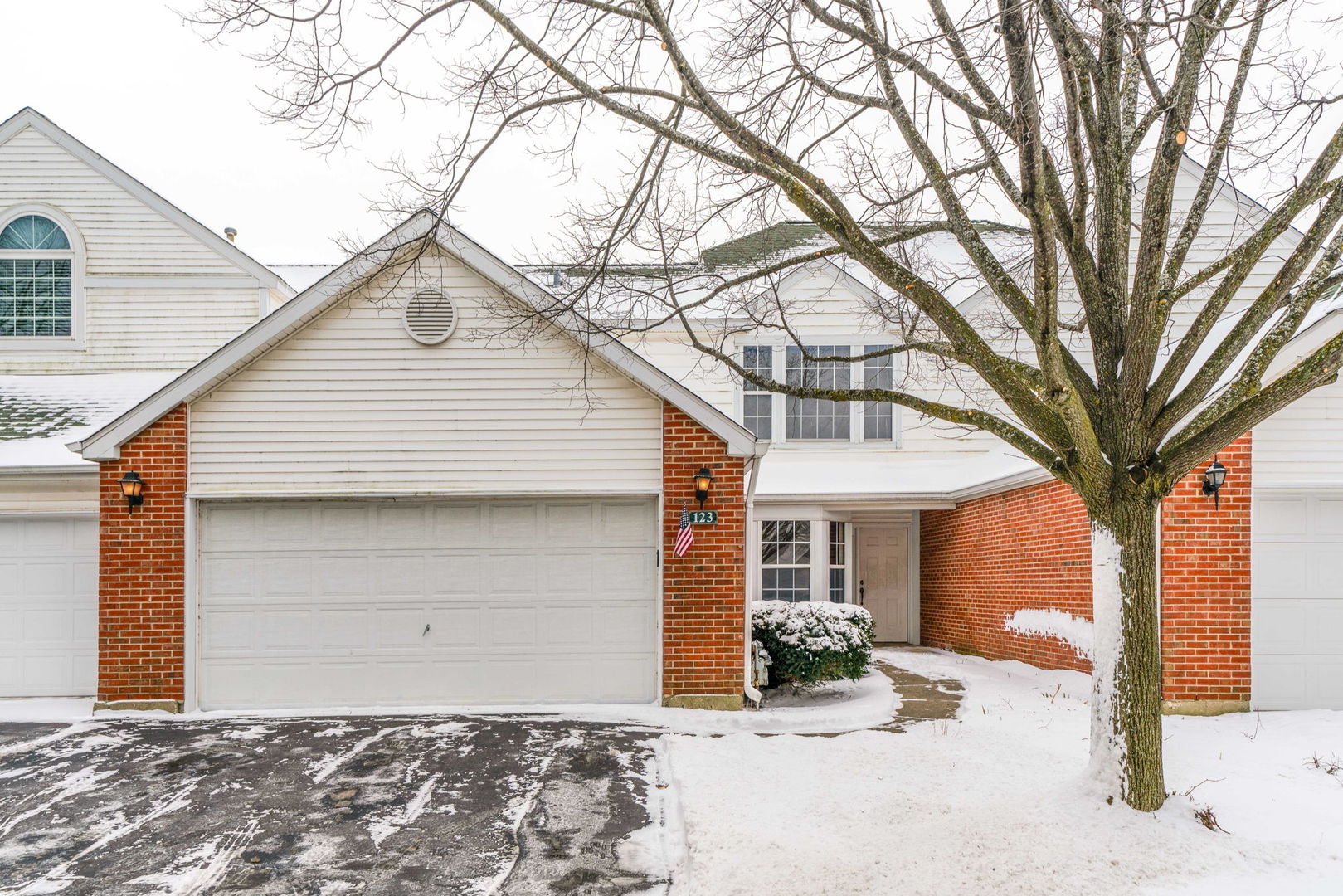 123 Hemstead Street, Unit 36D Lake Bluff, IL 60044 - Photo 2 of 3 a front view of a house with a yard and garage