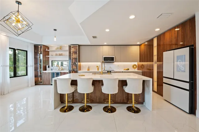 a large kitchen with a sink and center island
