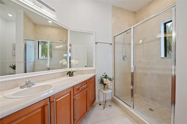 a bathroom with a granite countertop sink mirror and double
