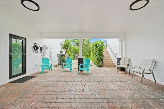 a view of a livingroom with furniture and a window